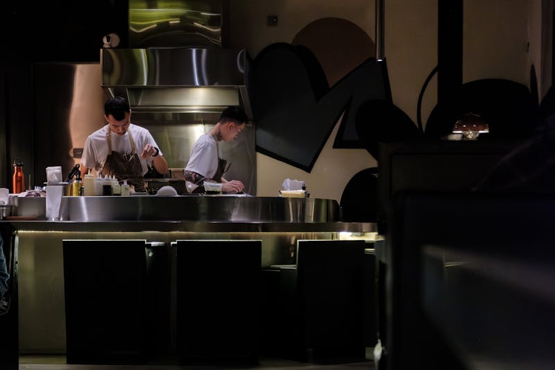 Open kitchen with chefs at work visible from dining area