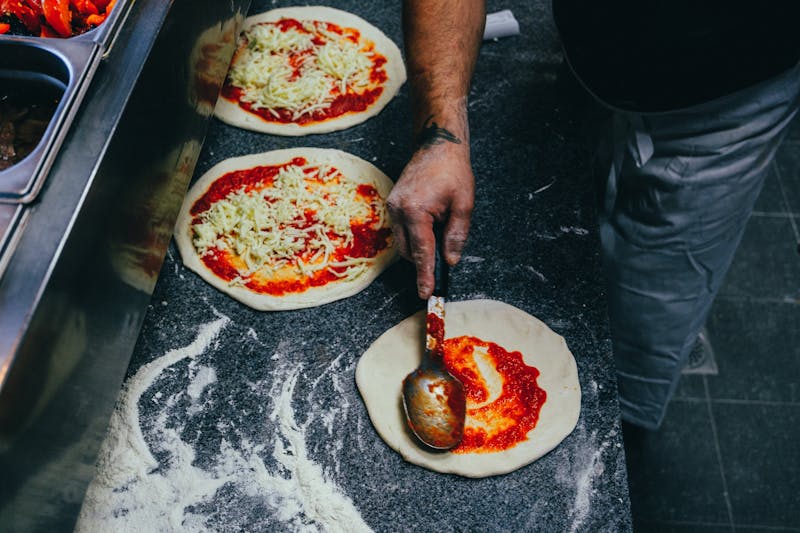 Community members learning pizza making at a workshop